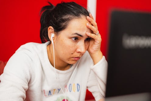 Woman looking stressed out at her computer