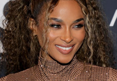  Ciara curly brown hair with blonde highlights.