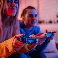 The best video games to play with friends being played by two women on the couch. 