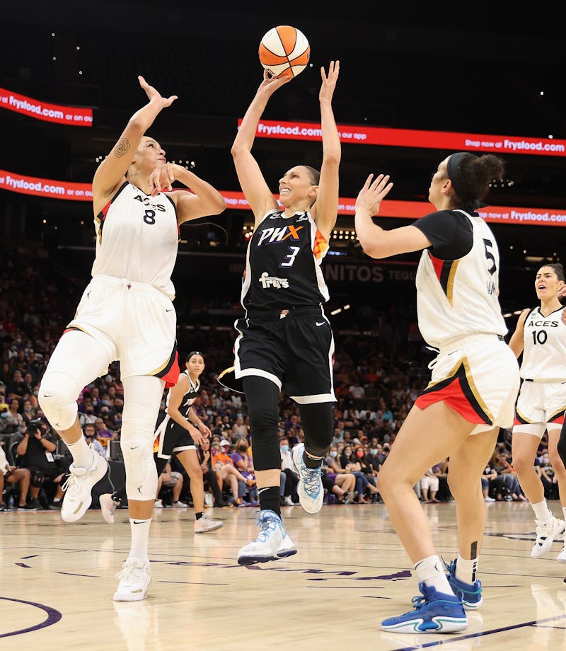 PHOENIX, ARIZONA - OCTOBER 06: Diana Taurasi #3 of the Phoenix Mercury attempts a shot over Liz Camb...