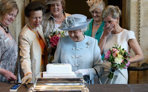 Queen Elizabeth II cuts a cake at the Centenary Annual Meeting of The National Federation Of Women's...