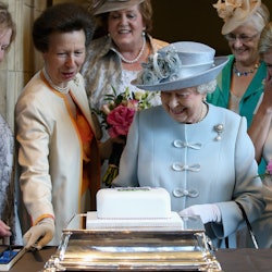 Queen Elizabeth II cuts a cake at the Centenary Annual Meeting of The National Federation Of Women's...