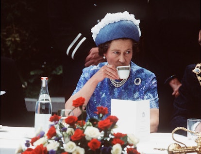 Queen Elizabeth ll has a cup of tea on a royal visit in 1977.