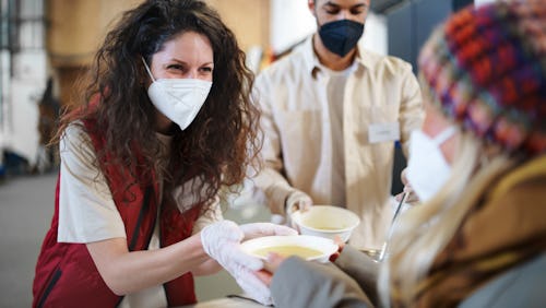 A woman works in a soup kitchen as part of MLK Jr. day of service volunteer work. Here's your daily ...