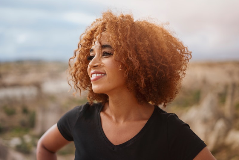 Portrait of smiling young woman with curly  hair