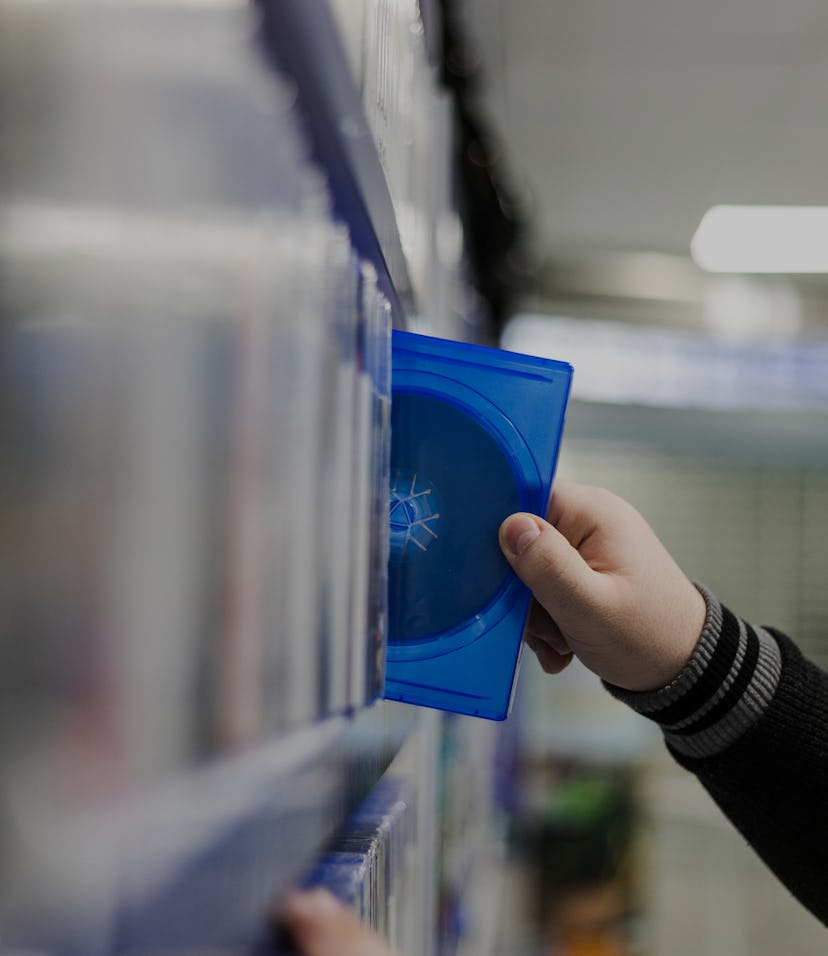 Profile of a handsome young guy browsing the gaming section at a local store