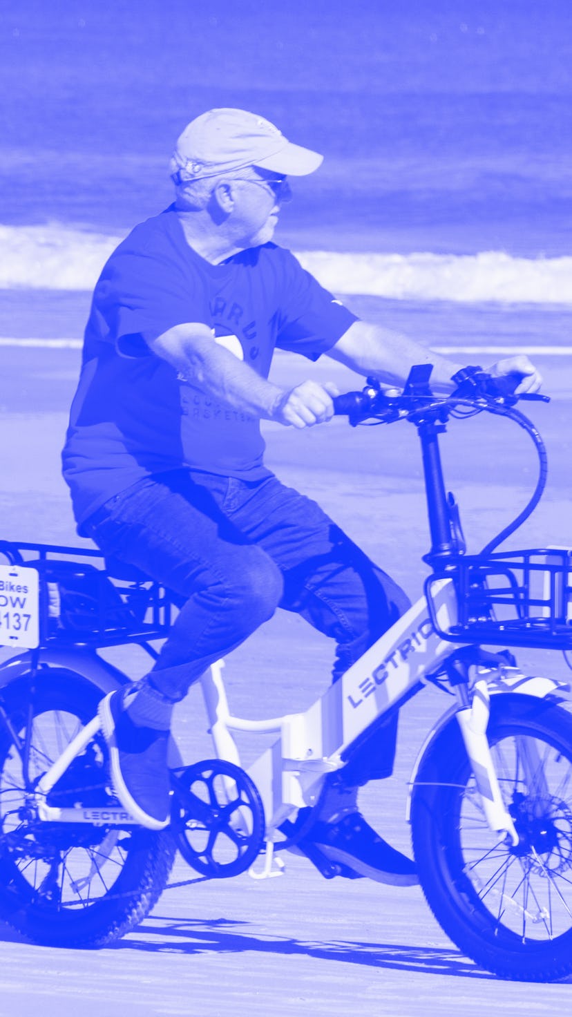 Daytona Beach, Florida, USA- December 29, 2021- A senior tourist rides his rented electric bicycle a...