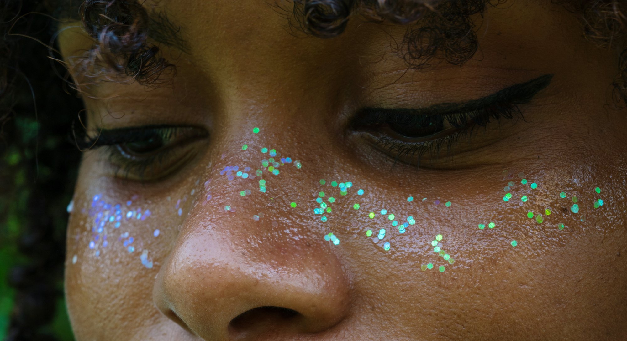 close-up portrait of a girl with glitter makeup. Celebrate your unique traits during Aquarius season...