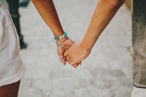 close up shot of a couple holding hands