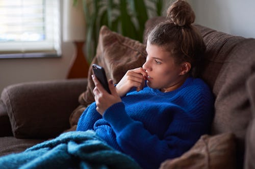 A woman in a blanket tries Wordle tips and strategies for winning Wordle.