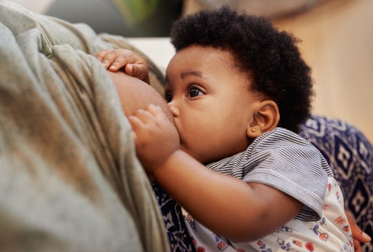 A mother breastfeeds her baby as new research comes out about the risk of transmitting Covid-19 thro...