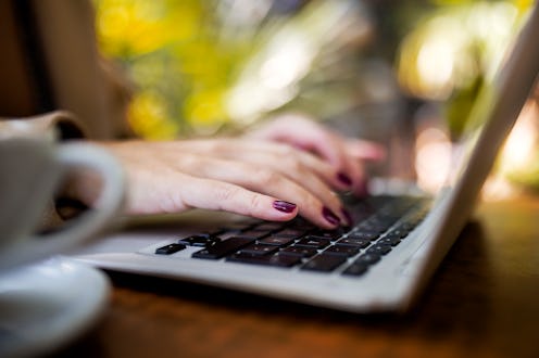 Unrecognizable woman typing on a laptop