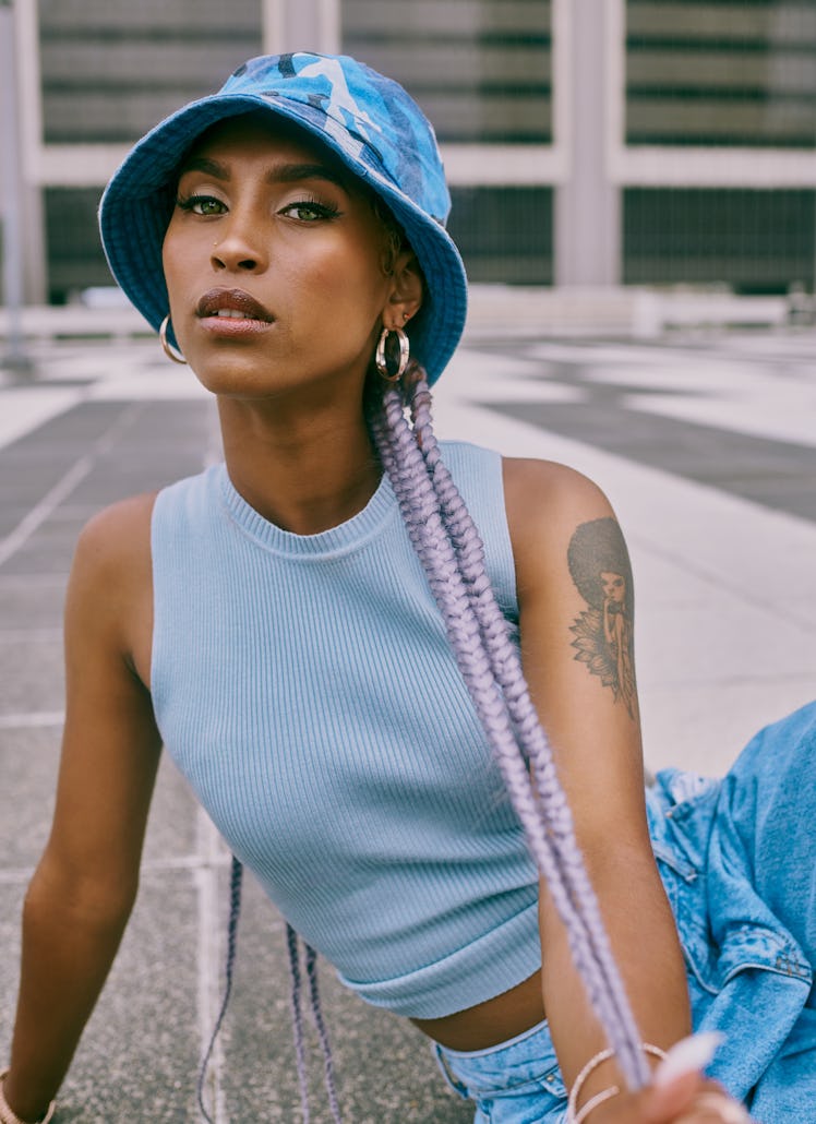 Young woman wearing hoop earrings, thinking about the January 31, 2022 weekly horoscope for her zodi...