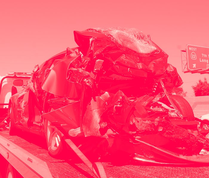 SEAL BEACH, CA - AUGUST 15: A damaged Tesla, right, and Honda Civic, sit on tow trucks after a colli...