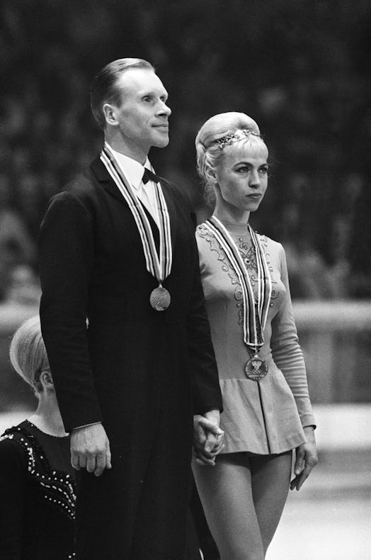 Lyudmila Belousova and her partner Oleg Protopopov from the Soviet Union stand of the podium of the ...