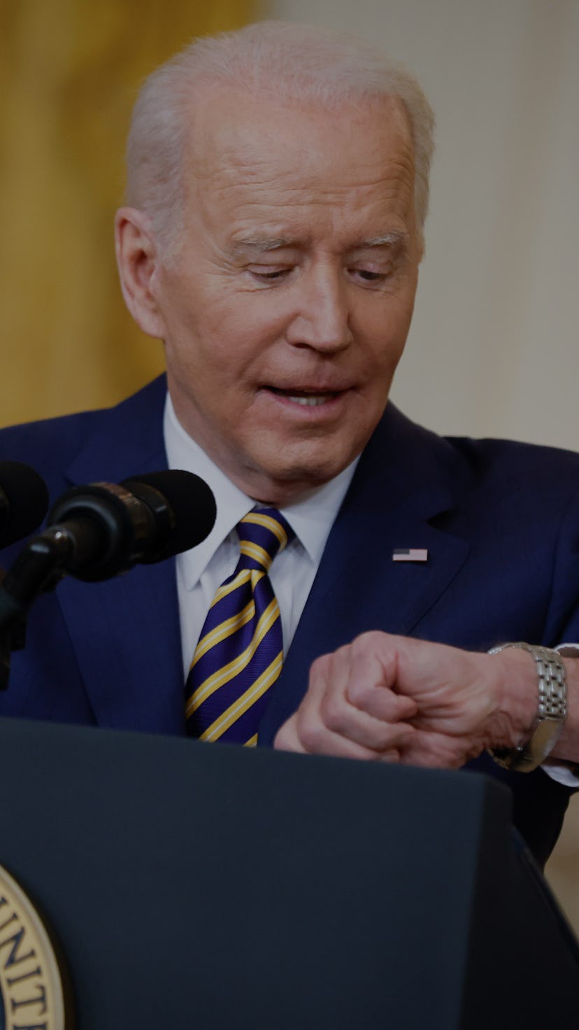 WASHINGTON, DC - JANUARY 19: U.S. President Joe Biden checks his watch while answering questions dur...