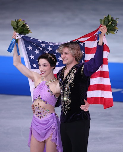 Meryl Davis and Charlie White of USA celebrates with a national flag after winning in the Figure in ...