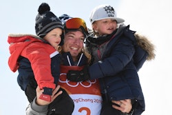 Gold medallist US David Wise celebrates on the podium with his children Nayeli and Malachi during th...