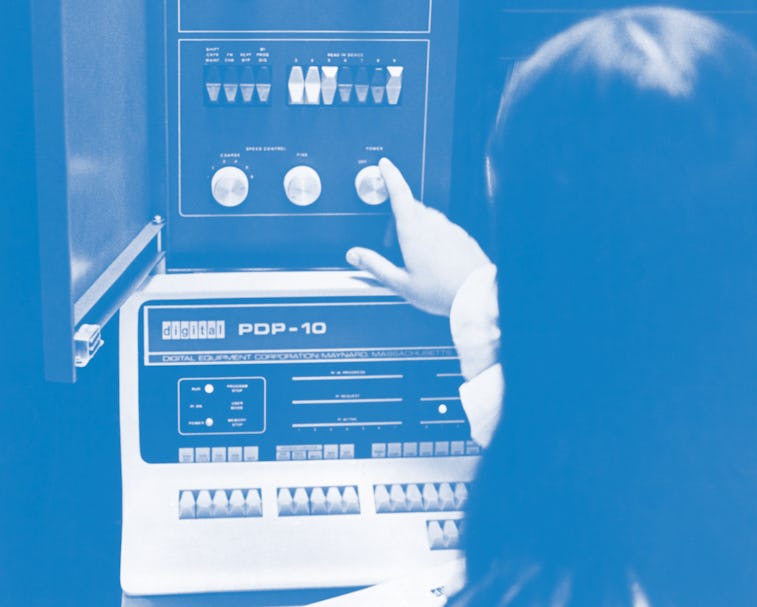 A woman adjusting an Applied Logic Corporation (AL/COM) time sharing AL-10 computer system, which co...