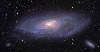 M106, spiral galaxy in Canes Venatici. This view captures the entire galaxy, detailing the glowing s...