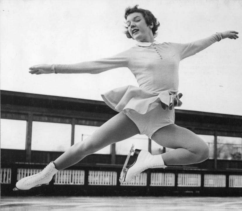 View of American figure skater Tenley Albright as she jumps from the ice, 1955. 