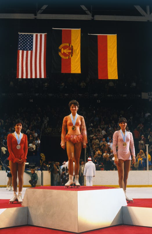 Winners of Olympics medals in the women's figure skating competition pose with their medals.