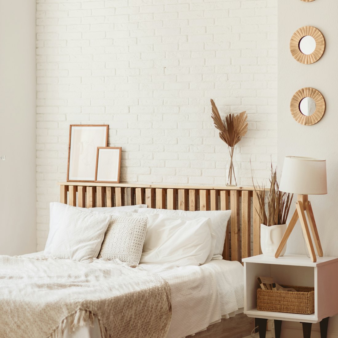 Light and spacious bedroom with white wall and eco DIY wooden furniture. Cozy bright bedroom in rust...