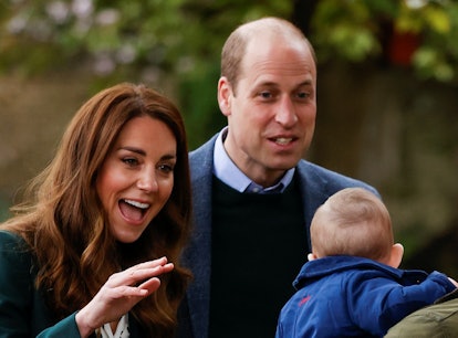 Kate Middleton and Prince William look excitedly at a baby.