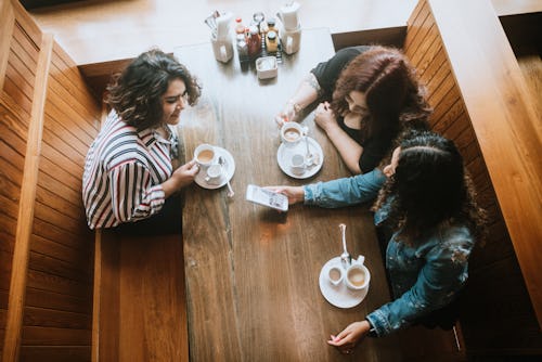 Three women have coffee in a restaurant. Here's how Mercury retrograde winter 2022 will affect each ...