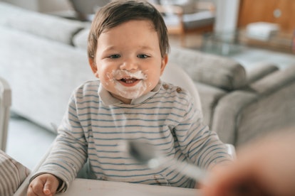 Baby eating Greek yogurt at home