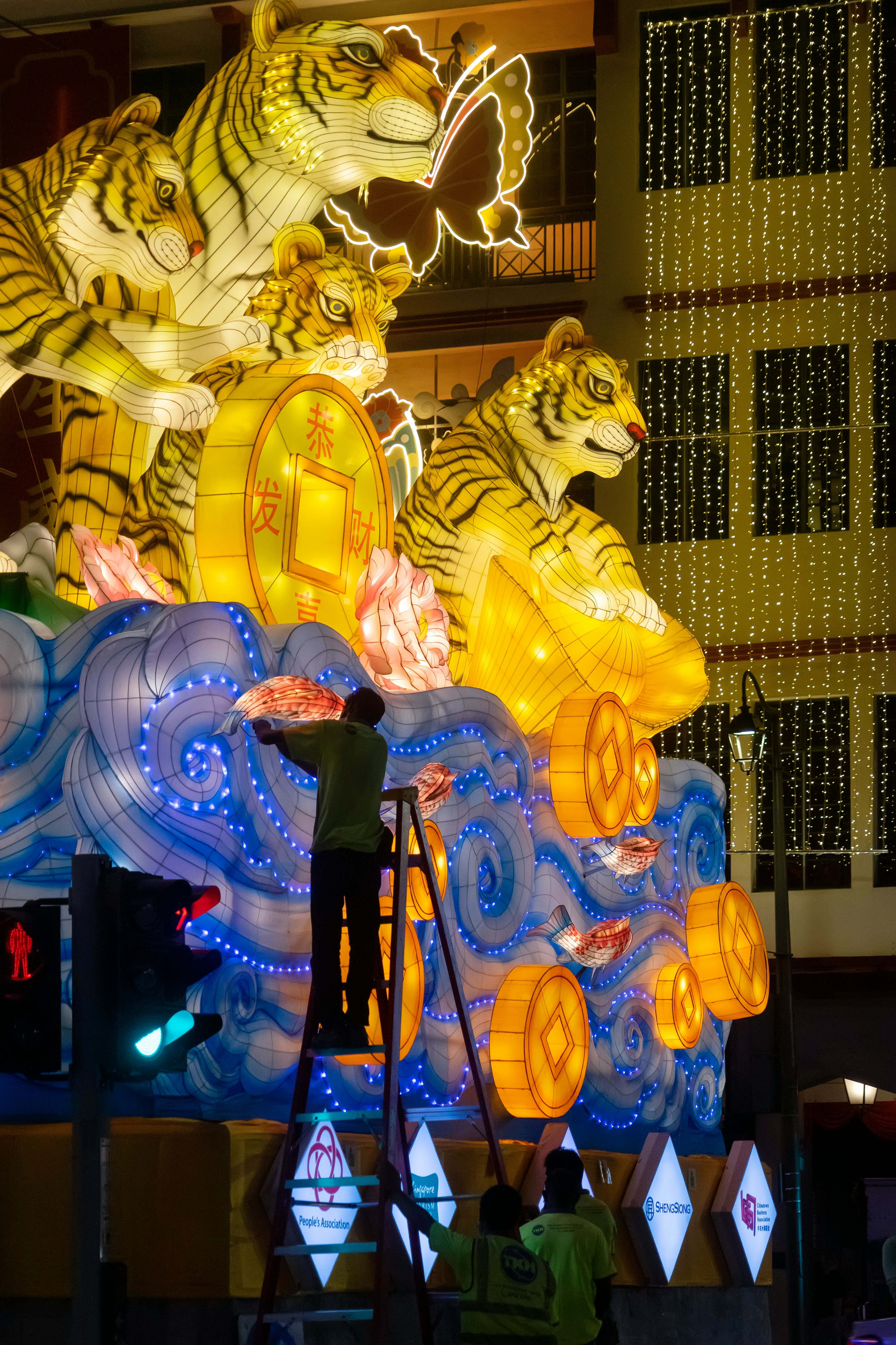 Singapore, Singapore - January 6, 2022: Workers making adjustments on a decorative installation of t...