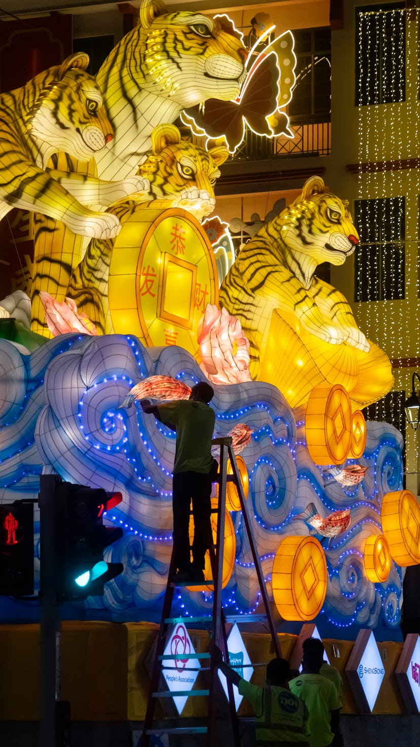 Singapore, Singapore - January 6, 2022: Workers making adjustments on a decorative installation of t...