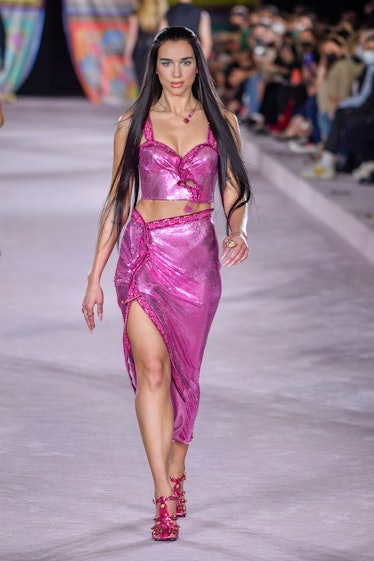 Dua Lipa with long, sleek hair walking the runway during the Versace Ready to Wear on September 24, ...