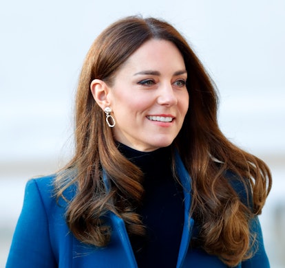 Kate Middleton wears a blue coat.