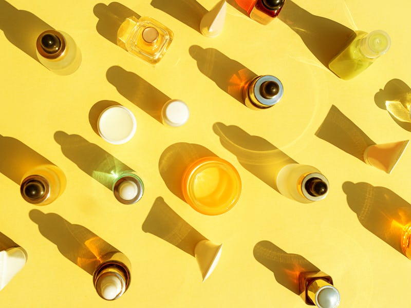 Trendy Beauty concept with Facial Serum, Natural Essential Oil, Hand cream, Lip balm and Perfume in ...