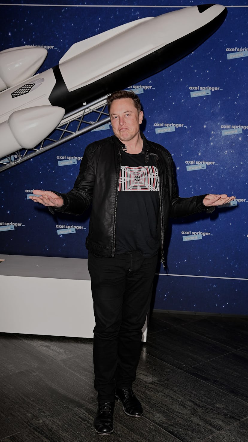 SpaceX owner and Tesla CEO Elon Musk (R) gestures as he arrives on the red carpet for the Axel Sprin...