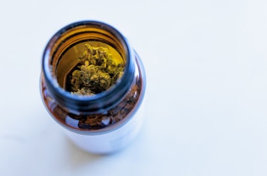 PRODUCTION - 14 January 2022, Baden-Wuerttemberg, Freiburg im Breisgau: A jar of medical cannabis si...