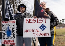 Demonstrators participate in a Defeat the Mandates march in Washington, DC, on January 23, 2022. - D...