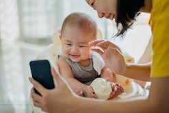 baby smiling into smartphone