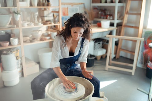 Woman making a ceramic pot in a workshop. These are aquarius zodiac sign's biggest weaknesses.