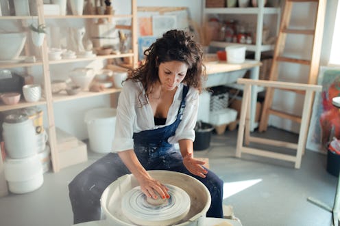 Woman making a ceramic pot in a workshop. These are aquarius zodiac sign's biggest weaknesses.