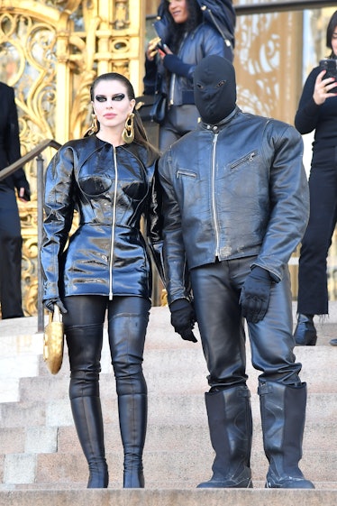 Kanye West and Julia Fox wearing matching all-black outfits. 