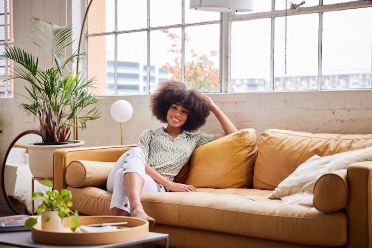 A woman shops Etsy's Airbnb "Art of Hosting" collection for her home decor.