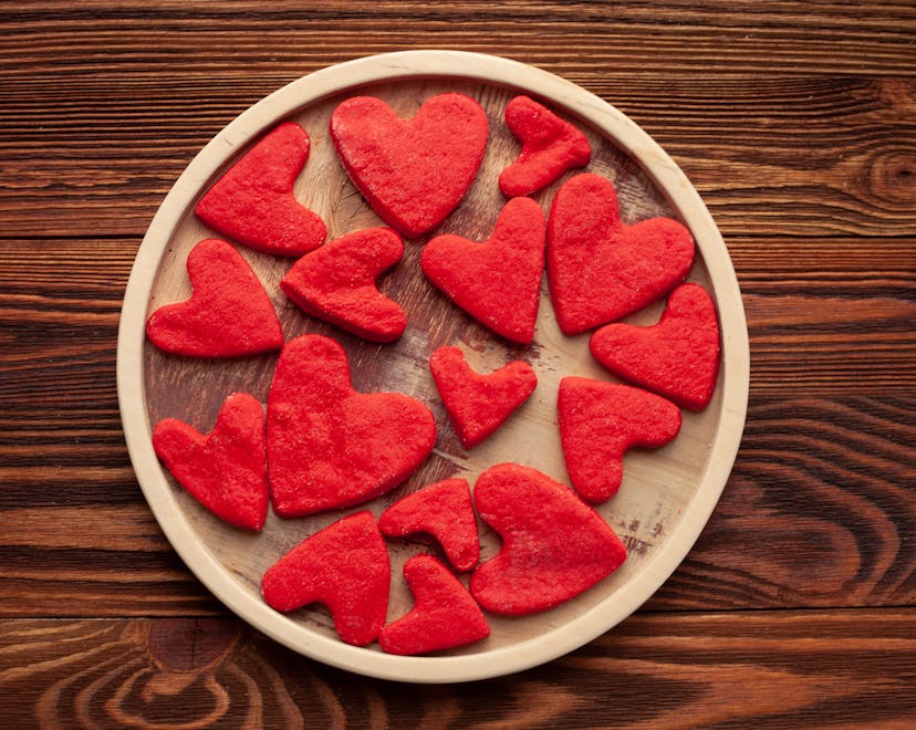 Red heart-shaped sweet cookies. Valentine's Day greeting card.