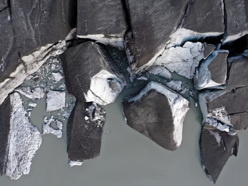 KANGERLUSSUAQ, GREENLAND - SEPTEMBER 08: In an aerial view, broken off sections of ice from the ret...