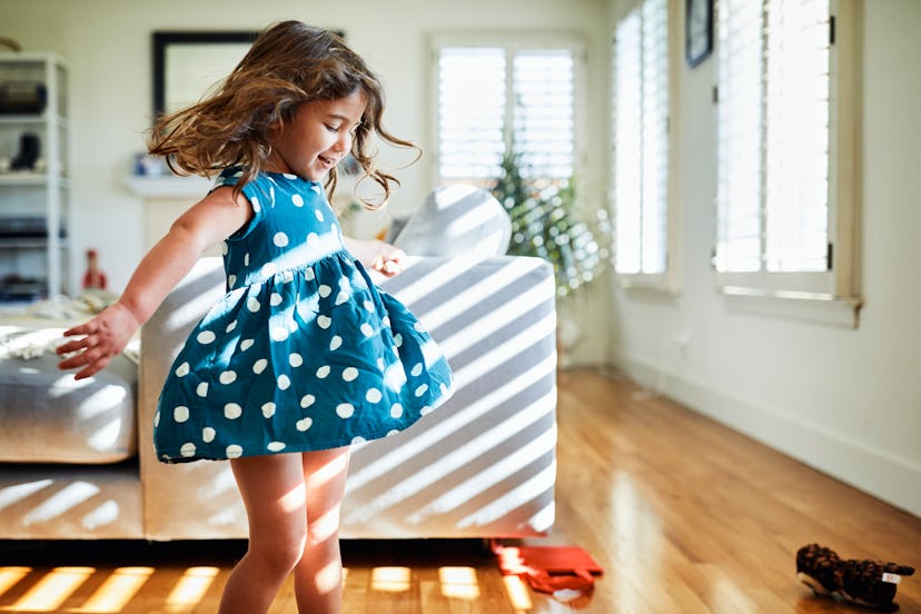 toddler dancing in sunny living room