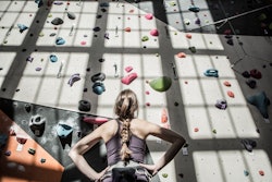 A woman stares up at a rock-climbing wall. Here's your daily horoscope for january 26, 2022.