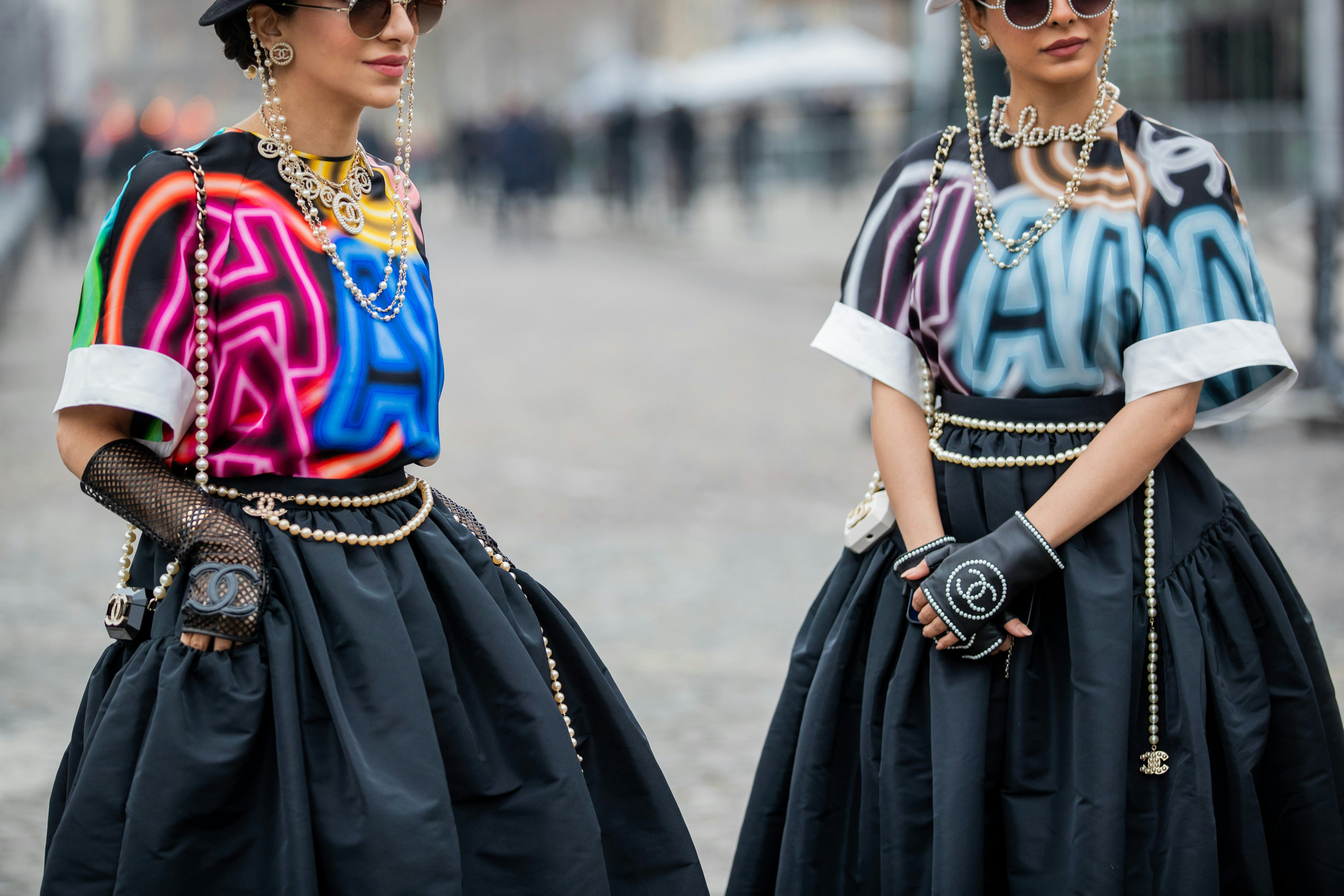 PARIS, FRANCE - JANUARY 25: Guests seen wearing top, necklace, jewellery, belt, skirt, sunglasses, g...
