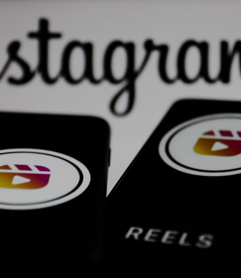 Instagram Reels logos displayed on a phone screens and Instagram logo displayed on a screen in the b...