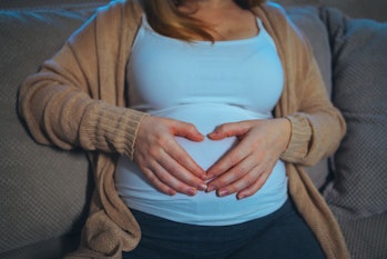 Pregnant woman with hands on her belly